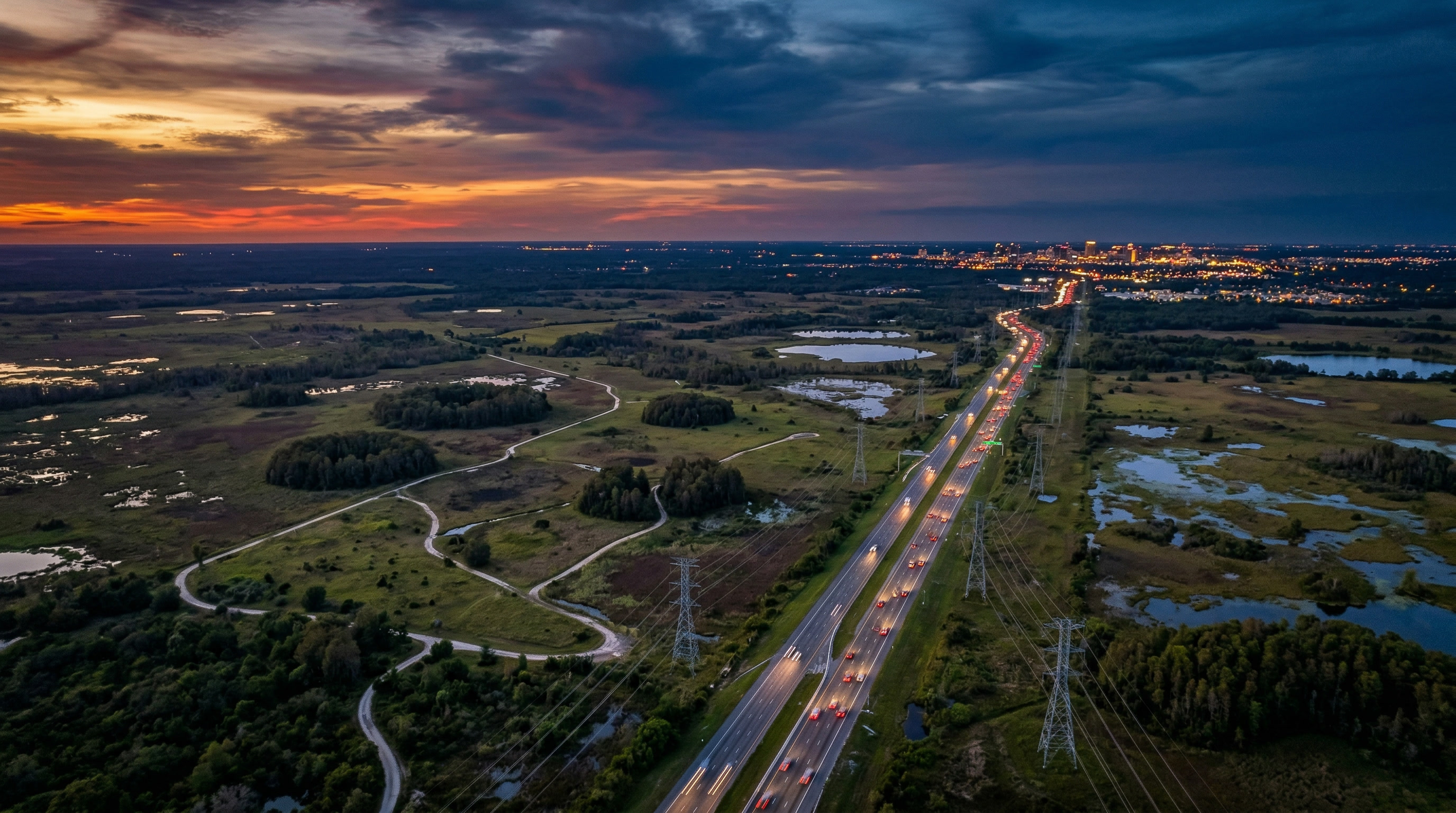 Aerial view of vast land at twilight with infrastructure stretching to the horizon